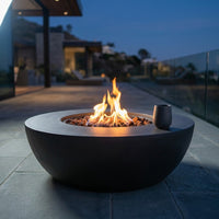 Brookhurst 43 In. W X 13 In. H round Outdoor GFRC Liquid Propane Fire Pit in Carbon with Lava Rocks — Studio Shot